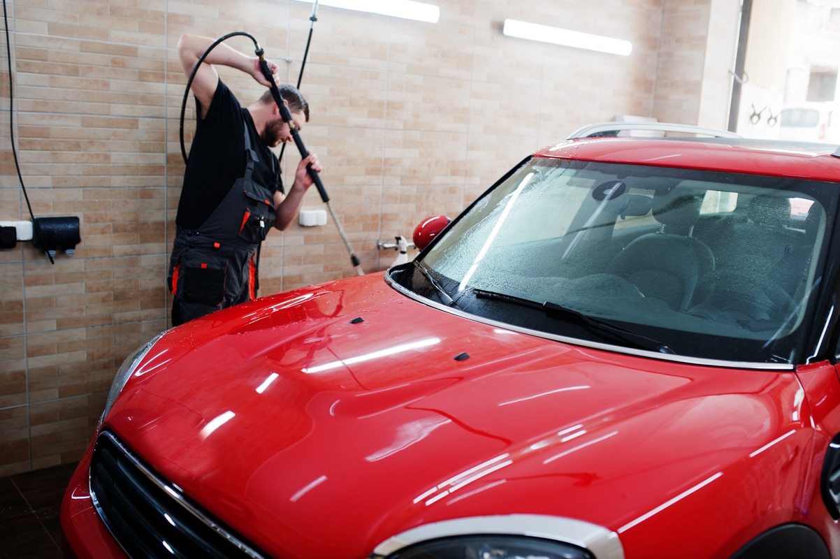 man worker washing red car detailing garage 800